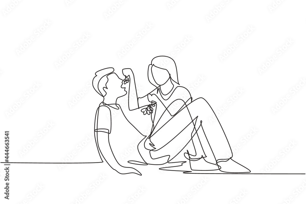 Continuous one line drawing romantic couple having picnic in summer park. Relaxing together sitting on the ground and women feeding grapes to men. Single line draw design vector graphic illustration