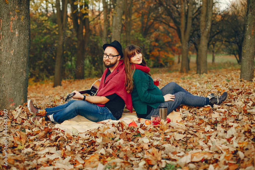 Elegant couple spend time in a autumn park Elegant couple spend time in a autumn park