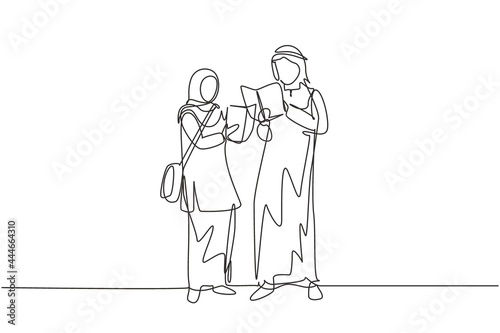 Single continuous line drawing Arabian students woman and man reading  learning and standing at library. Literature lovers  education concept. Dynamic one line draw graphic design vector illustration