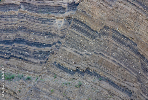 different layers of rock in a rocky wall