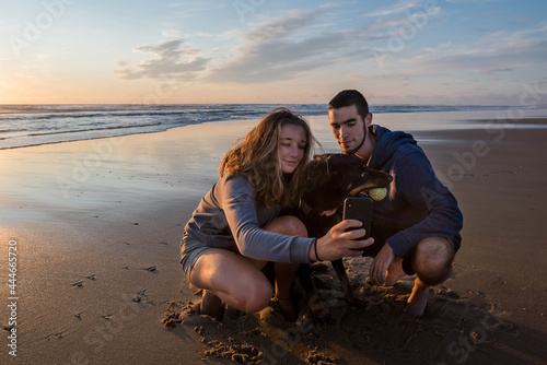 young couple and their dog making selfies on vacation