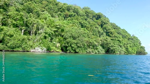 A tropical island paradise and turquoise green blue water from a boat in Bougainville, Papua New Guinea photo