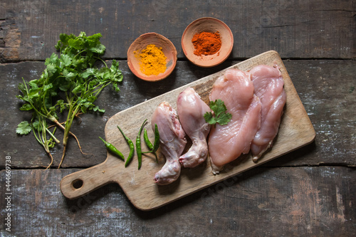 Raw chicken meat slab on wooden platter with use of selective focus 
