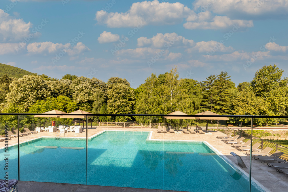View to a outdoor swimming pool in a modern hotel