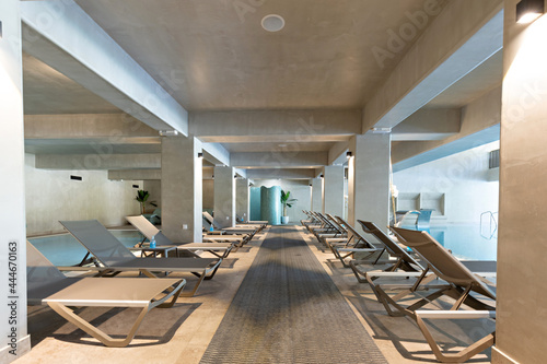 Sunbeds in a row in indoor swimming pool