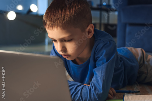 Young boy engaged in online...