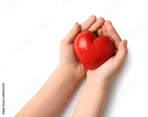 Child s hands with red heart on white background