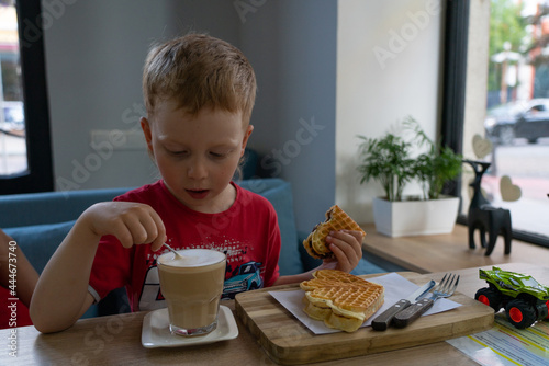 boy drinking coffee in a cafe