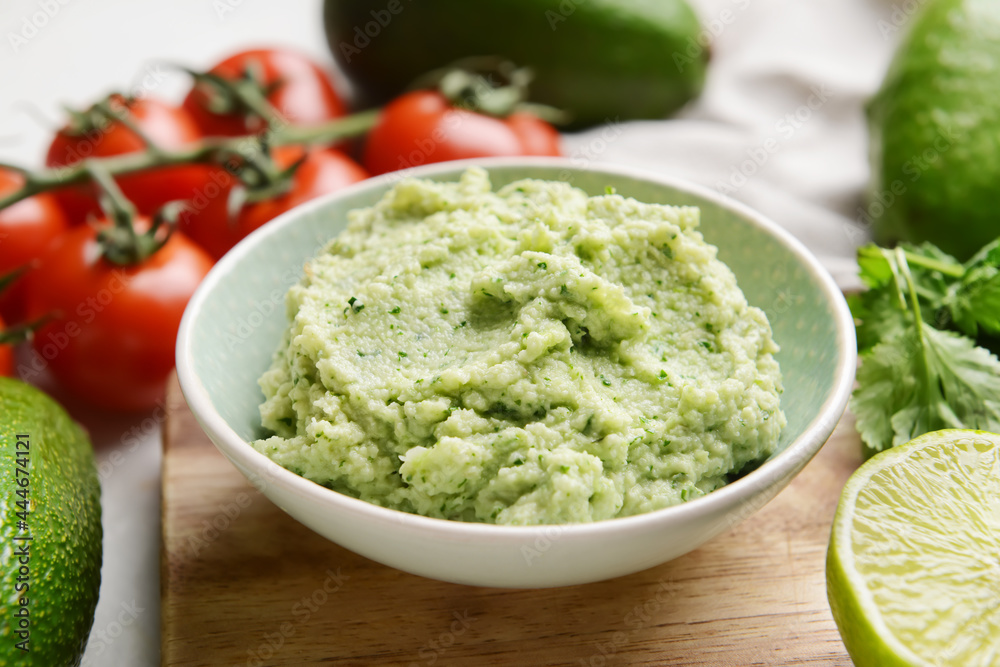 Bowl with tasty guacamole and lime on table, closeup Bowl with tasty guacamole and lime on table, closeup