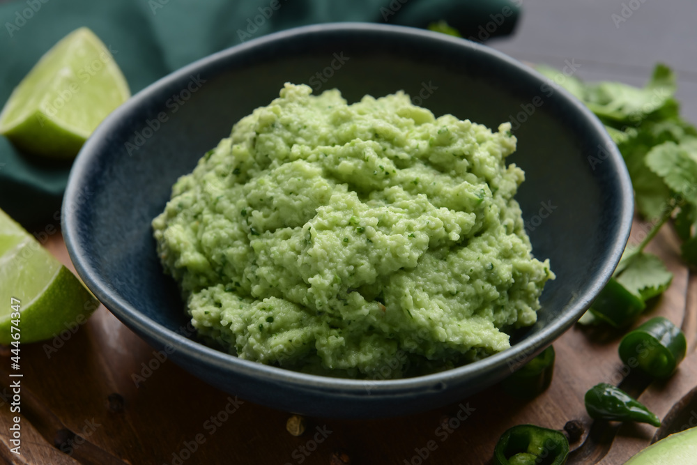 Bowl with tasty guacamole and lime, closeup Bowl with tasty guacamole and lime, closeup