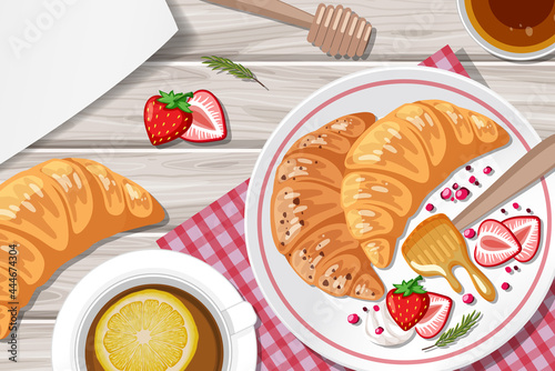 Croissant with strawberry and a cup of lemon tea on the table