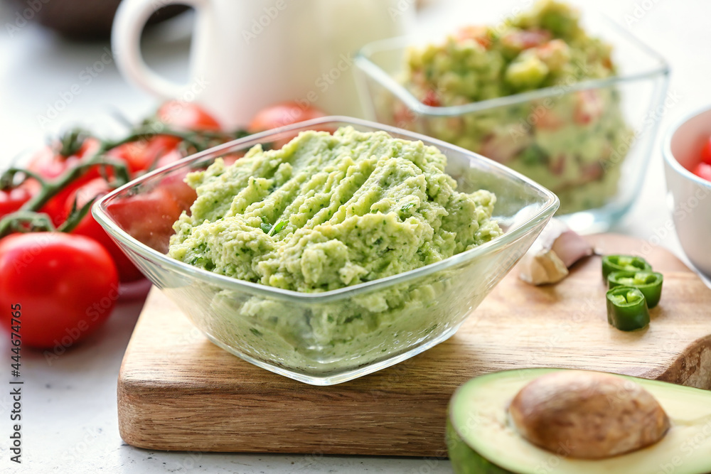 Bowl with tasty guacamole on table, closeup Bowl with tasty guacamole on table, closeup