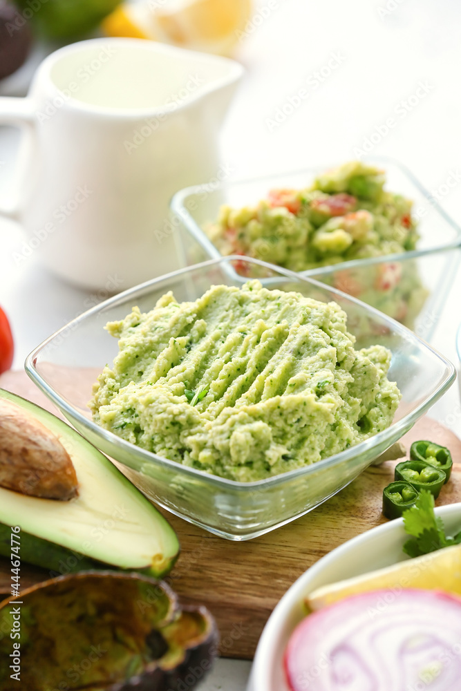 Bowl with tasty guacamole on table, closeup Bowl with tasty guacamole on table, closeup