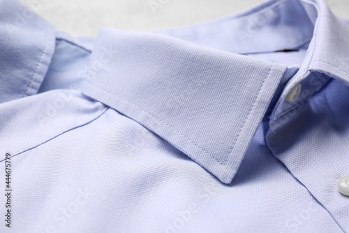 Stylish male shirts on light background, closeup