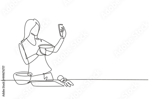 Continuous one line drawing pretty housewife taking selfie or making video call using her smartphone while cooking fresh salad. Healthy food concept. Single line design vector graphic illustration