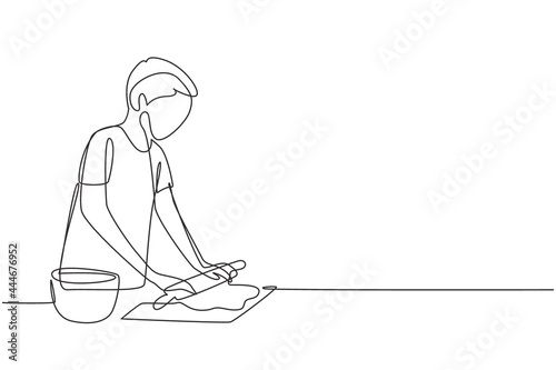 Single continuous line drawing young man making cookie dough using rolling pin at cozy kitchen table. Making bakery and homemade pizza at home. Dynamic one line draw graphic design vector illustration