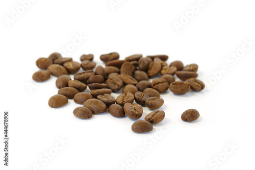 Coffee beans are pouring into a white background.