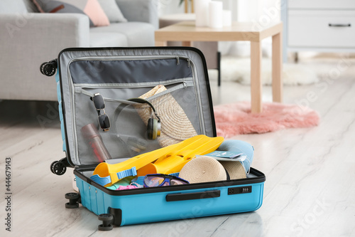 Suitcase with belongings in...