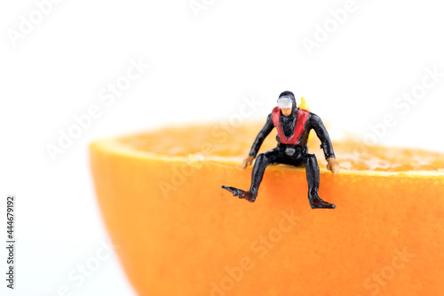 Diver miniatures sitting on oranges