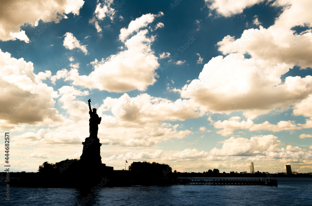 Statue of Liberty with a dramatic blue sky