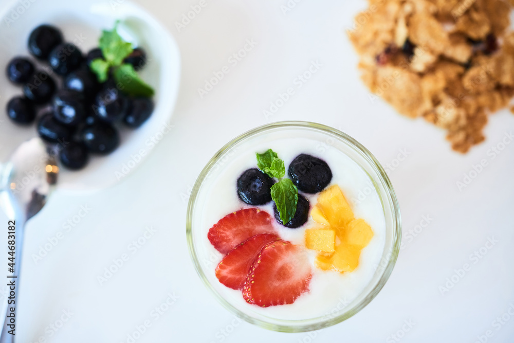 Sweet tasty low calorie dessert with fresh berries on kitchen table, view from above Sweet tasty low calorie dessert with fresh berries on kitchen table, view from above