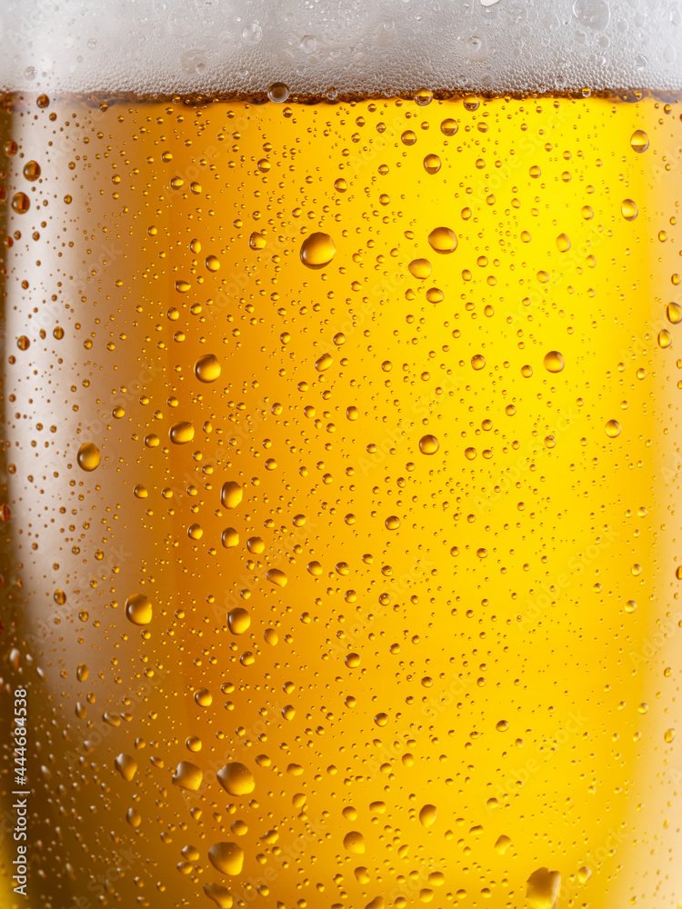 Cooled glass of beer close-up. Small water drops on cold surface of beer glass. Cooled glass of beer close-up. Small water drops on cold surface of beer glass.