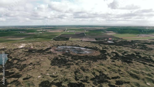 Salt Marshes With Agricultural Landscape At Background Near National Park Of Texel Wadden Island In Netherlands. - Aerial Shot photo