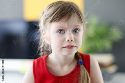 Fotografi Portrait of little emotional girl with pensively frightened look closeup