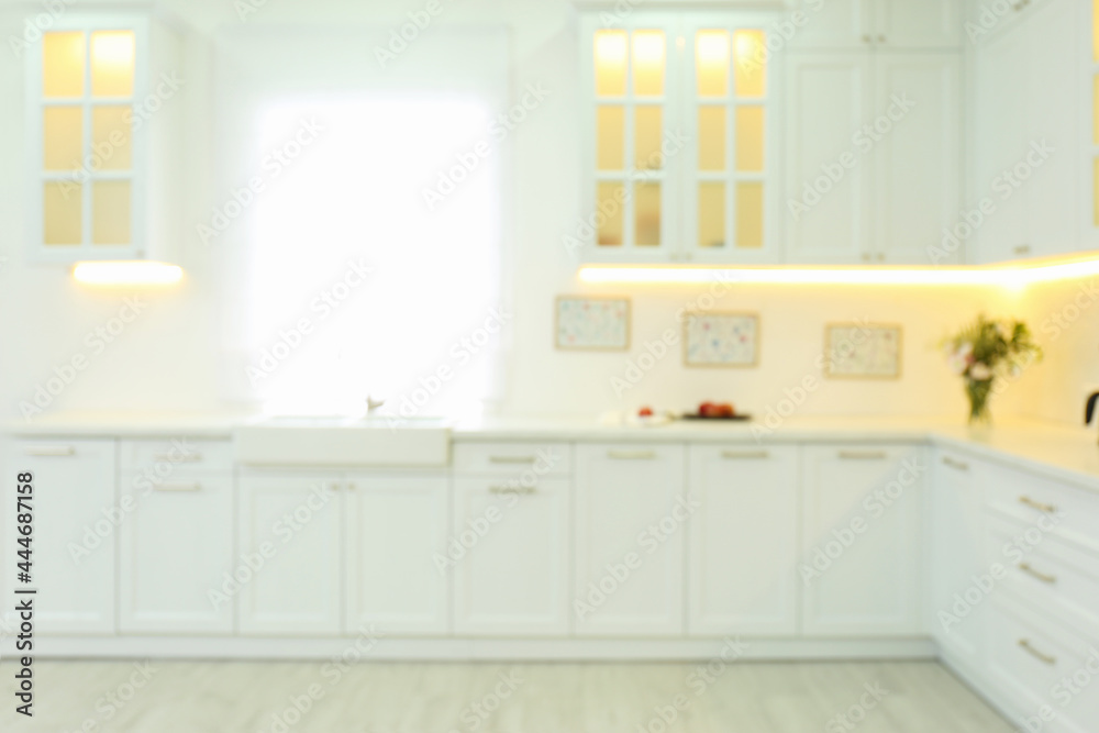 Fototapeta premium Blurred view of modern kitchen interior with stylish furniture