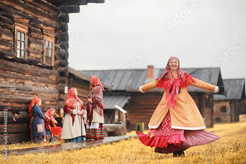 Traditional Slavic rituals in the rustic style. Outdoor in summer. Slavic village farm. Peasants in elegant robes.