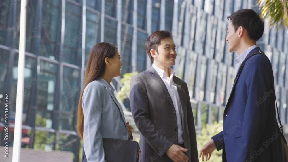 asian business people shaking hands greeting each other outdoors on street in downtown financial district asian business people shaking hands greeting each other outdoors on street in downtown financial district