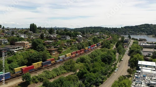 Cinematic 4K aerial drone footage of passing trains at Sunset Hill by Loyal Heights, Adams, Lawtonwood, Ballard Bridge, Shilshole Bay Marina, Ballard, Seattle, by Puget Sound photo