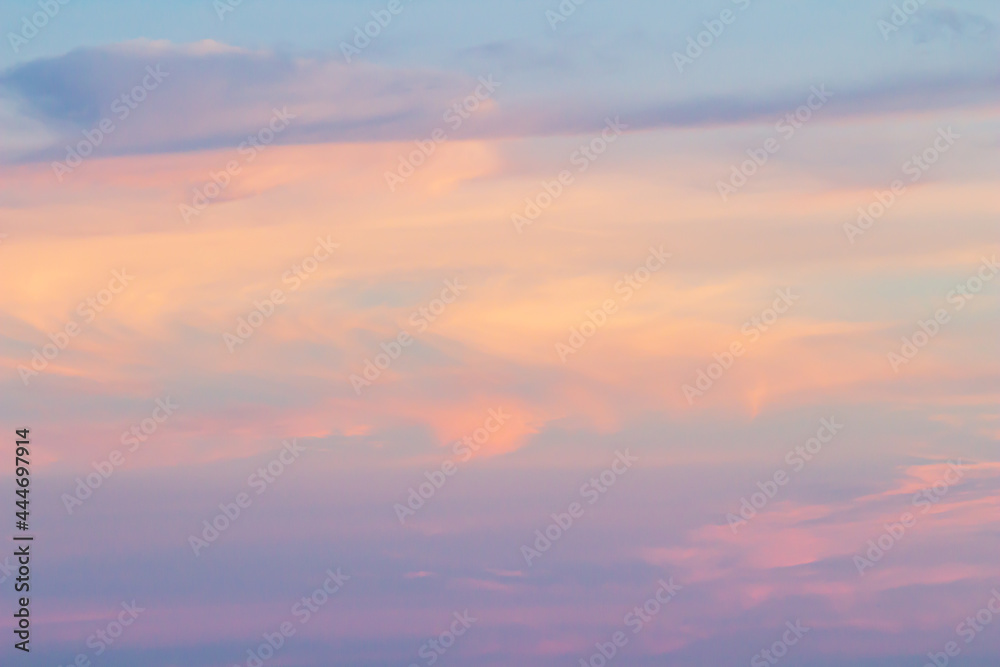 Sunset sky background with pink, purple and blue dramatic colorful clouds, vast sunset sky landscape