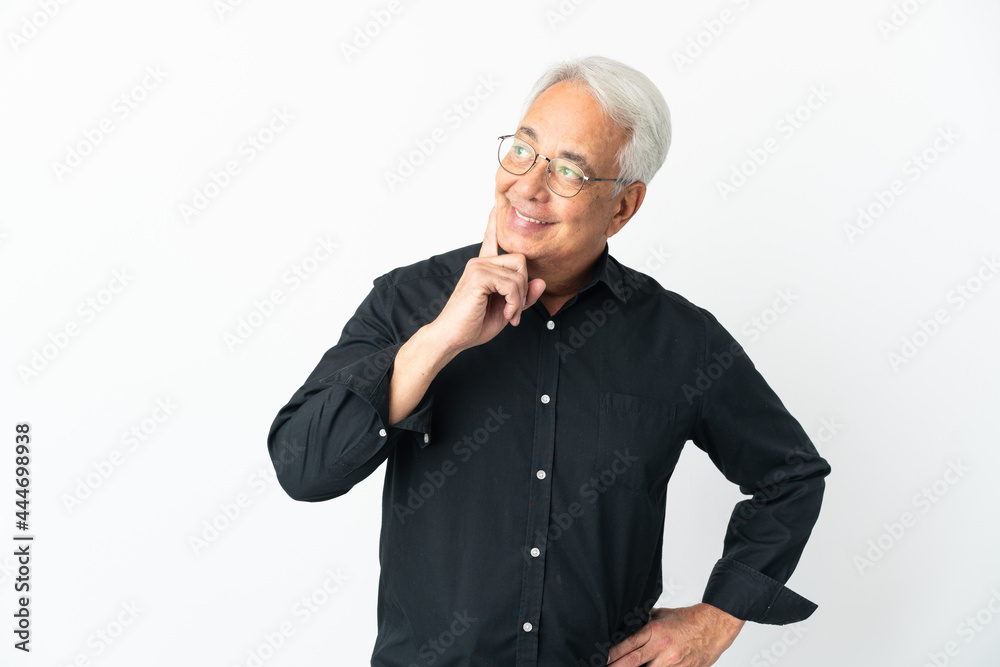 Middle age Brazilian man isolated on white background thinking an idea while looking up Middle age Brazilian man isolated on white background thinking an idea while looking up