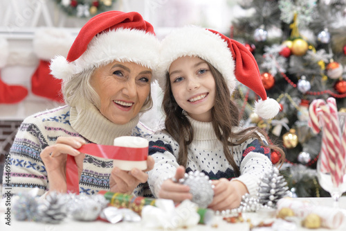 Happy grandmother with child girl preparing for Christmas photo