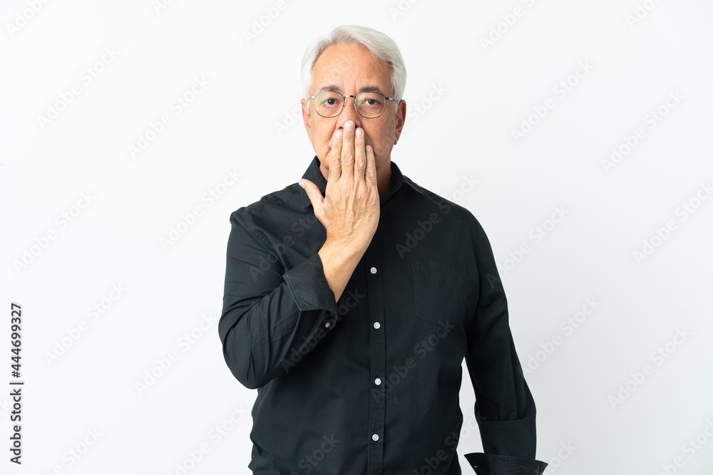 Middle age Brazilian man isolated on white background covering mouth with hand Middle age Brazilian man isolated on white background covering mouth with hand
