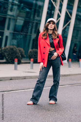 glamour woman in trendy outfit posing against the building urban background, fashion look. Outdoor fashion portrait of stylish young woman