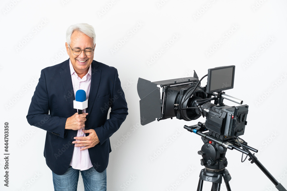 Reporter Middle age Brazilian man holding a microphone and reporting news isolated on white background smiling a lot
