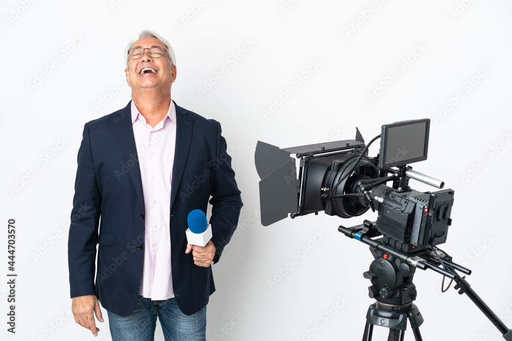 Reporter Middle age Brazilian man holding a microphone and reporting news isolated on white background laughing