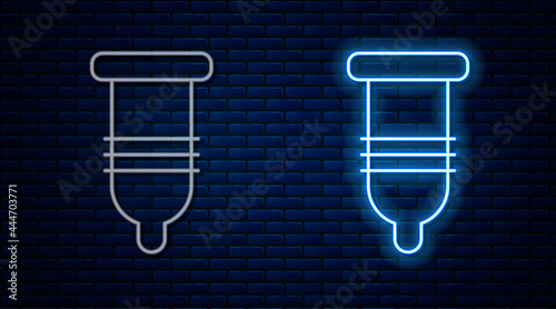 Glowing neon line Condom safe sex icon isolated on brick wall background. Safe love symbol. Contraceptive method for male. Vector