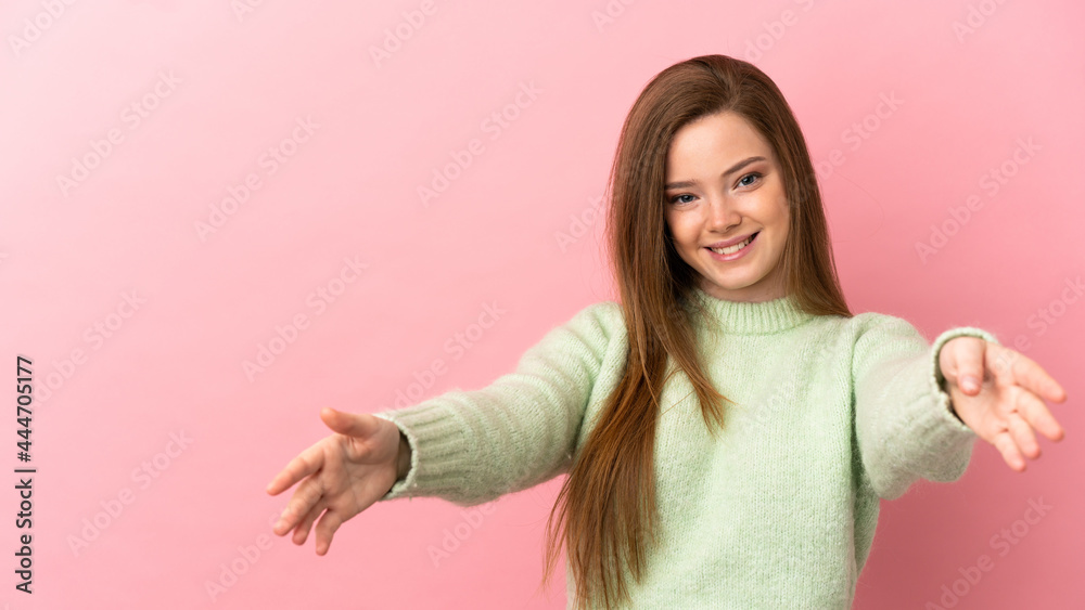 Teenager girl over isolated pink background presenting and inviting to come with hand Teenager girl over isolated pink background presenting and inviting to come with hand