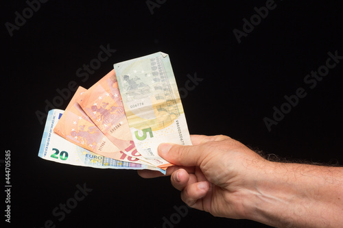 Banknotes of money in hand on black background