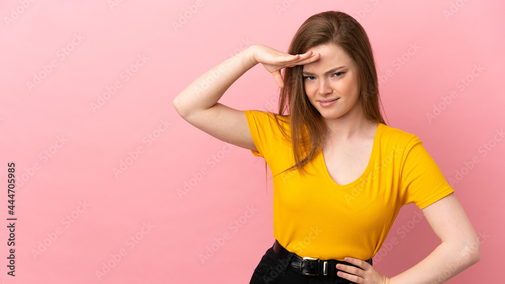 Teenager girl over isolated pink background looking far away with hand to look something Teenager girl over isolated pink background looking far away with hand to look something