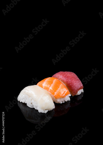 Nigiri sushi with salmon, tuna, hake on black background. photo