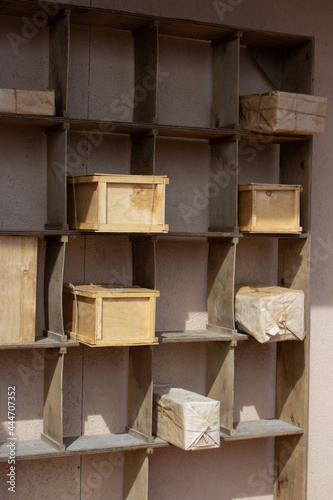 Open wooden shelves on which the indicated parcels lie in wooden boxes. Free space in empty cells.