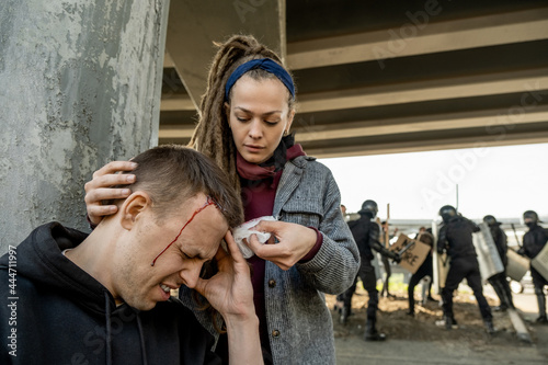 Woman helping to stop blood to man