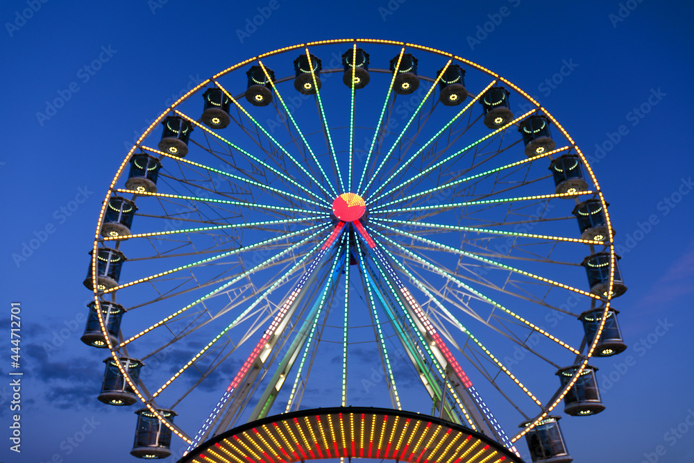 High Ferris Wheel against dark night sky in our summer vacation at Adriatic seaside. Amusement park ride. Holidays concept. High Ferris Wheel against dark night sky in our summer vacation at Adriatic seaside. Amusement park ride. Holidays concept.