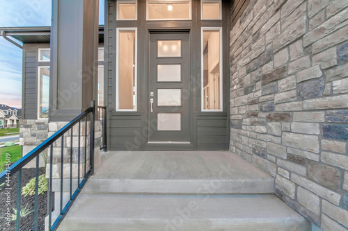 Canvas Print Front view of the house entrance with glass panelled front door and sidelights