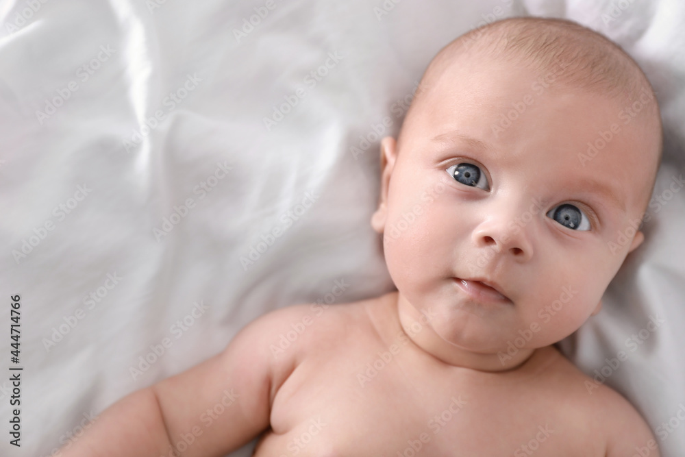 Cute little baby lying on bed, top view Cute little baby lying on bed, top view