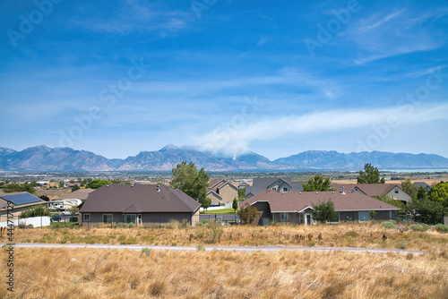 Residential houses in Utah Valley with view of wildfire in the Wasatch Mountains